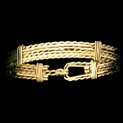 Gold 6 wire bracelet on a black background