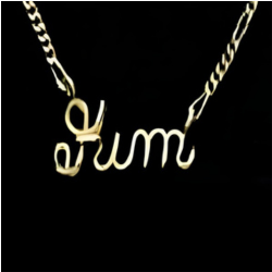 Gold necklace with ‘Kim' pendant on a black background