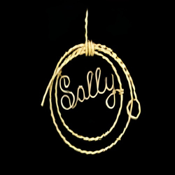 Circular necklace with 'Sally' text on a black background